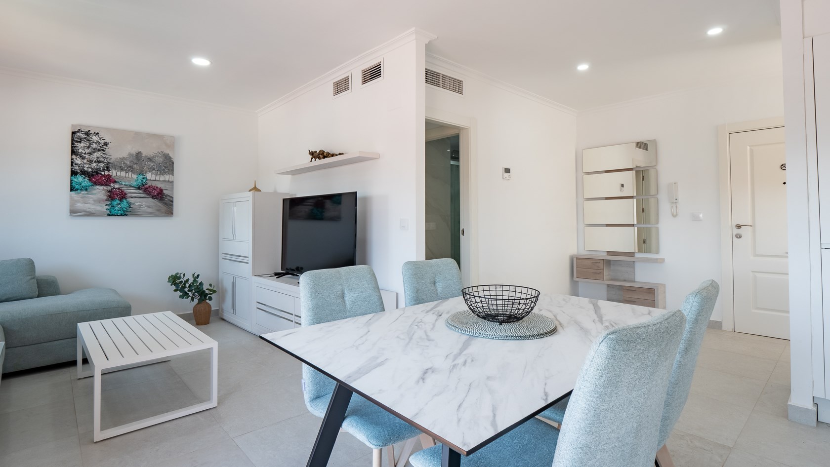 Open-plan living room with marble dining table