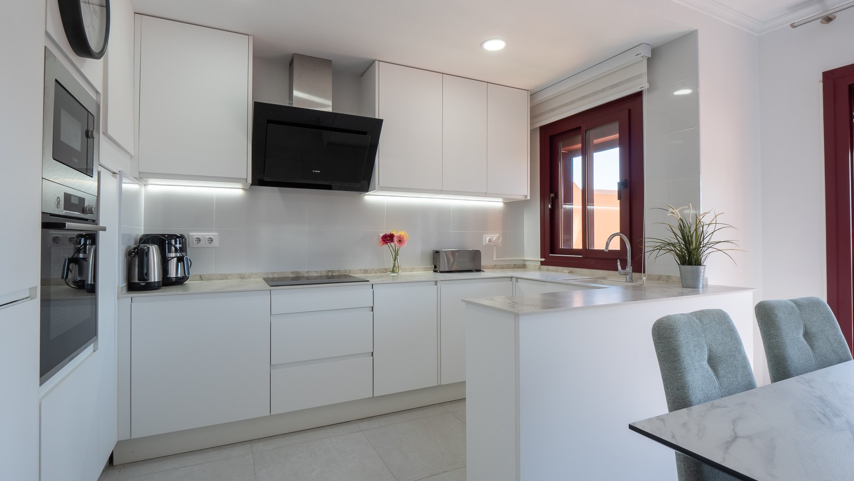 Bright white kitchen with breakfast bar